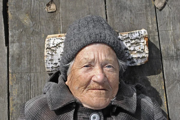 Elderly Grandmother Smiling Looking Camera Wearing Coat Hat Lies Gray — Stock Photo, Image