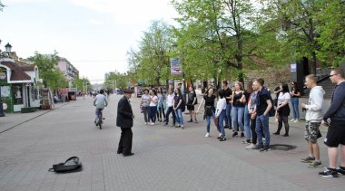 Chelyabinsk, Rusya - 10 Mayıs 2019. Takım elbiseli yaşlı bir büyükbaba insanlarla konuşur. Kalabalık büyükbabaya bakıyor..