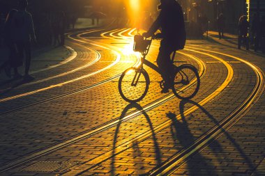 Gün batımı sırasında bisiklet sürme bir adamın bulanık 