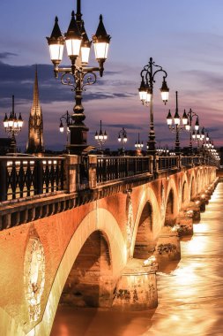 Twilight at Pont de Pierre bridge in Bordeaux, France clipart
