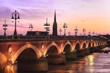 Pont de Pierre bridge with St Michel cathedral, Bordeaux, France clipart