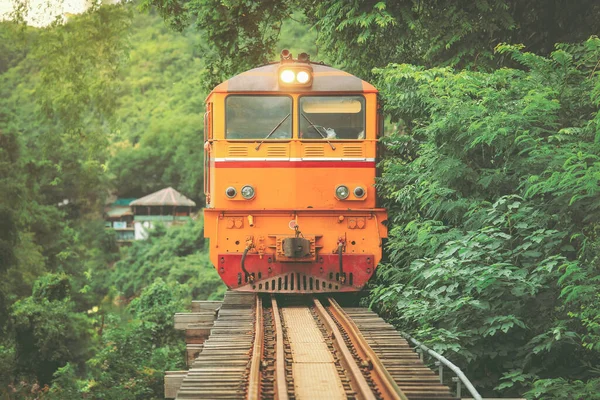 The train on the bridge over the river Kwai in Kanchanaburi, Thailand. This bridge is famous for its history in second world war.