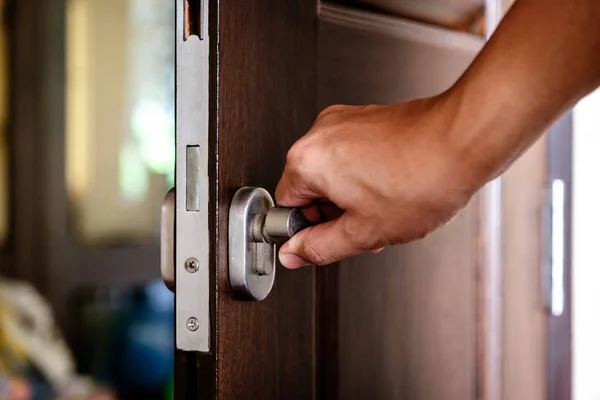 Hand locking the wooden door