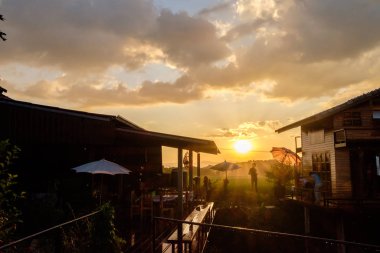 Çiftlik arazilerinde kamp alanı ve panoramik günbatımı olan otlaklar.