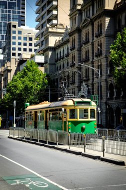 Famous Melbourne city cycle trams with tour groups at Australia