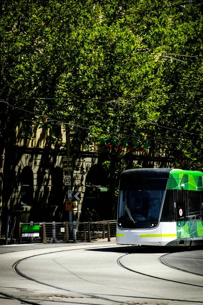 Famous Melbourne city cycle trams with tour groups at Australia
