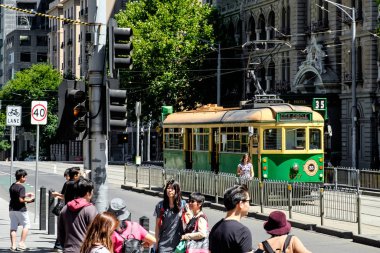 Famous Melbourne city cycle trams with tour groups at Australia