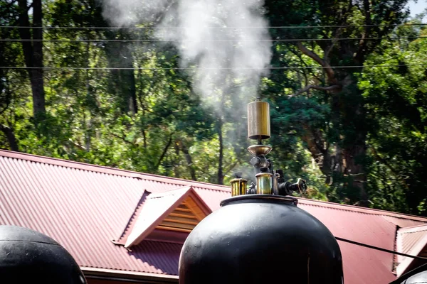 The white steam smoke released from the exhaust pipe of the traditional steam engine train at Melbourne, Australia