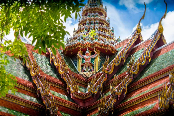 Ornate budist temple ceiling of thailand with blue sky