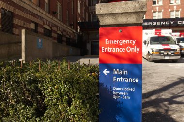 Vancouver, Canada - February 20, 2020: Close up view of Vancouver St. Paul Hospital emergency sign in red with directional arrow points towards the main entrance