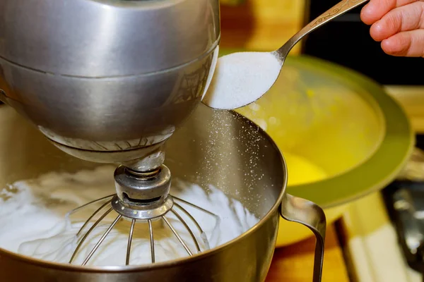 The mixer whipping egg whites. Woman adds sugar to mixer bowl. — Stock Photo, Image