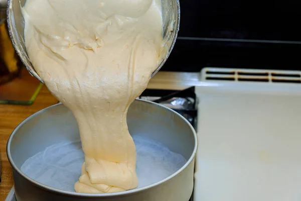 Pouring cake dough into a baking pan. — Stock Photo, Image