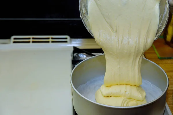 Pouring fluffy dough into round baking pan for sponge cake. — Stock Photo, Image