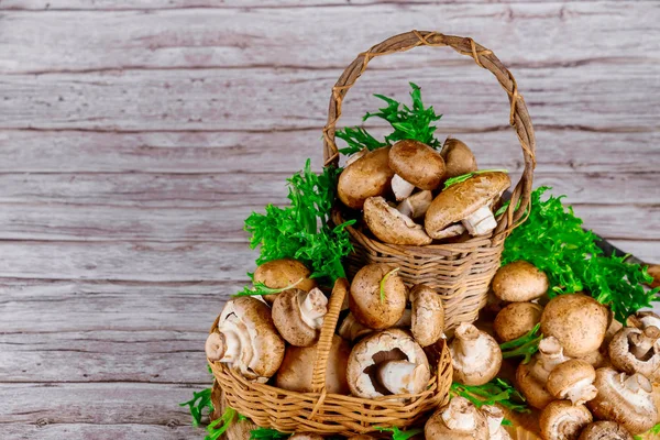 Champignon marrone portobello in due cestini di vimini su un tavolo di legno . — Foto Stock