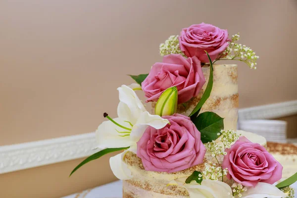 Wedding naked cake decorated with purple roses. — Stock Photo, Image