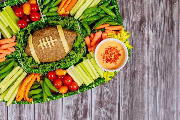 Football meatloaf with vegetable and dipping for Super Bowl fan party. — Stock Photo, Image