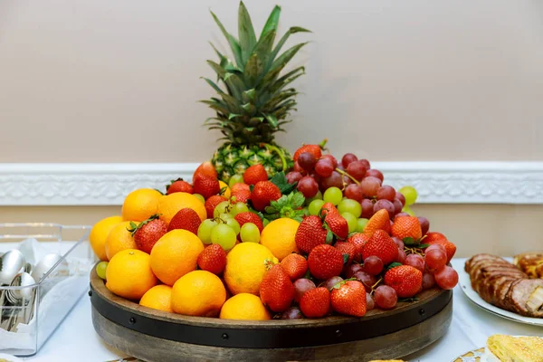 新鲜成熟的水果盘，有葡萄、草莓、橘子、菠萝 — 图库照片