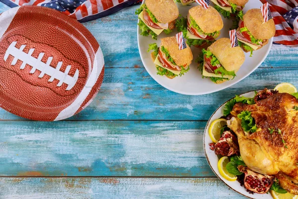 Party table for sport fans with food for watching american football game.