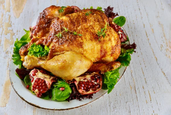 Roasted turkey on plate with herbs and pomegranate. — Stock Photo, Image