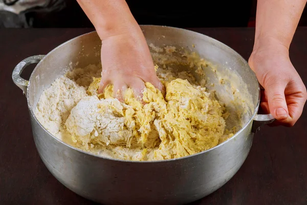 Woman kneads or mixing yeast dough for making buns. — Stock Photo, Image