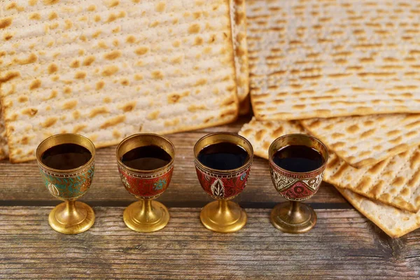 Four cups full of wine with matzah. Jewish holidays Passover.