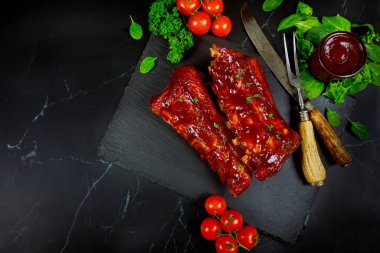 Domuz pirzolası, barbekü sosu, domates ve ıspanak..