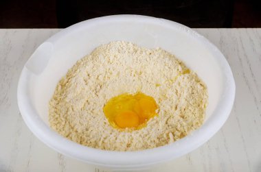 Ingredients of cookie dough egg, sugar, butter and flour.