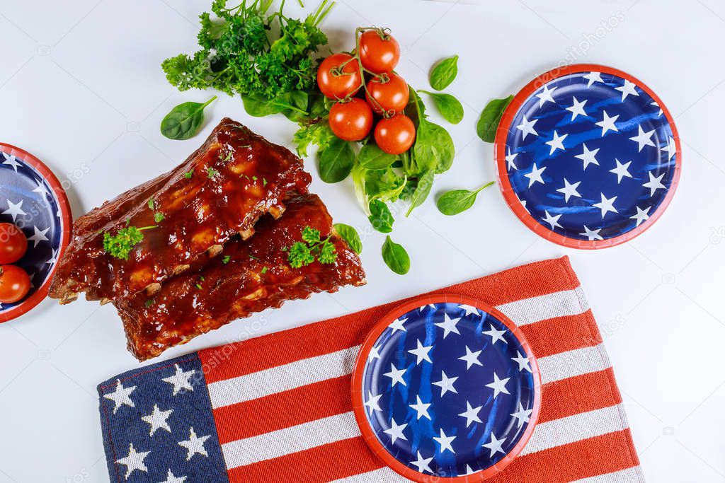 Festive party table with ribs and vegetable for american holiday.