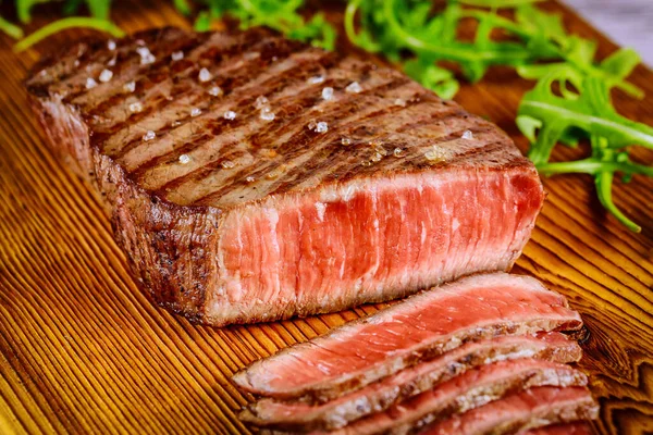 Grilled prime ribeye beef steak on wooden board. — Stock Photo, Image