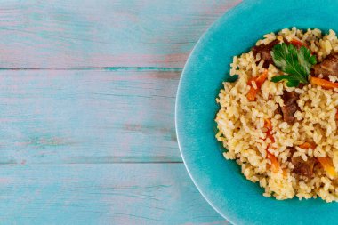 Sebzeli kızarmış pilav, tabakta tavuk ve mavi arka plan. Çin mutfağı..
