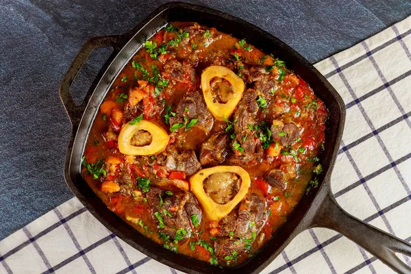 Cooked beef shank with vegetable and wine. Ossobuco Italian cuisine.