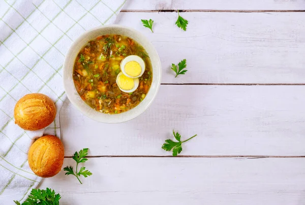 Healty sorrel soup with egg and crusty rolls on wooden background. — Stock Image Healty Sorrel Soup Egg Crusty Rolls Wooden Background Royalty Free Stock Photos