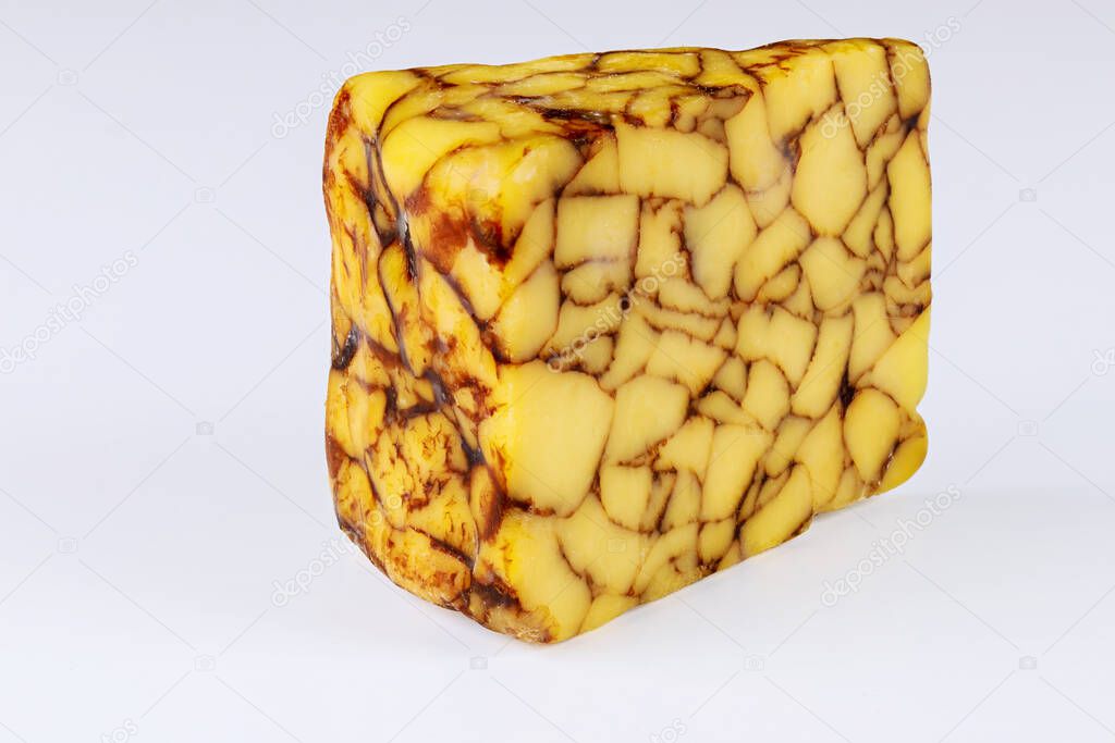 Chunk of cheddar Irish porter cheese on white isolated background.