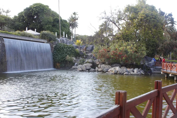 Big rock waterfall into tropical garden — Stock Photo, Image