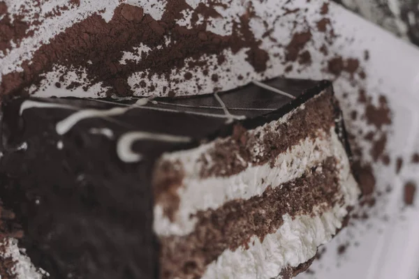 Un morceau de gâteau au chocolat noir avec deux couches de crème — Photo
