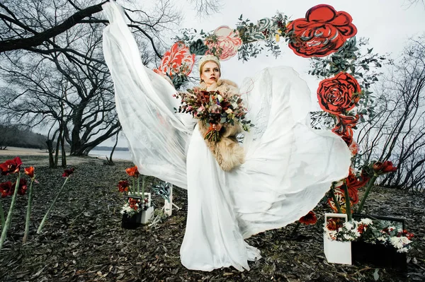 luxurious Russian bride dressed kokoshnik Christmas spirit, Russian style in a beautiful white dress that flies in different directions, a wedding bouquet