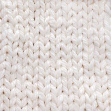 Beyaz örülmüş doku arka planı. Sıcak kışlık kıyafetler.