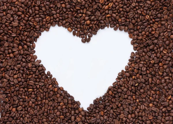 Coffee heart. Heart shape made from coffee beans. Top view