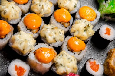 Büyük bir rulo ve suşi seti. Sostan şapka. Pişmiş ekmek. Yakın plan.