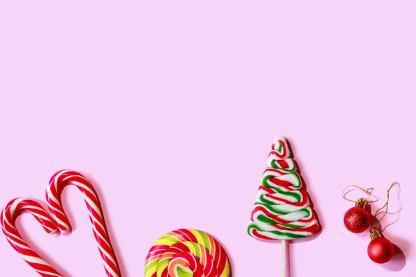 Julgodis och sötsaker på en rosa bakgrund. Minimal kreativ design. — Stockfoto