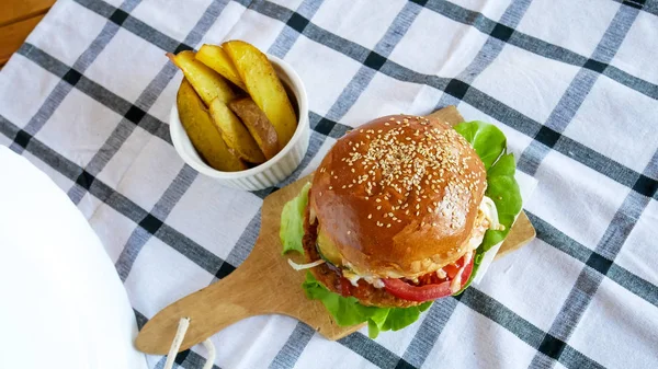 Meaty hamburger in a restaurant — Stock Photo, Image