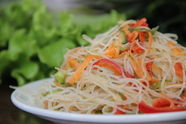Cellophane in Korean with vegetables. Rice glass noodles with carrots, cucumber and bell pepper in a pan