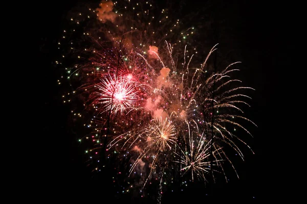 Beautiful new years firework celebration in black evening sky. — Stock Photo, Image