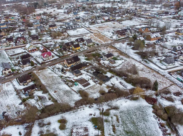 Areal view of suburbs with small amount of snow. Photo taken in winter.