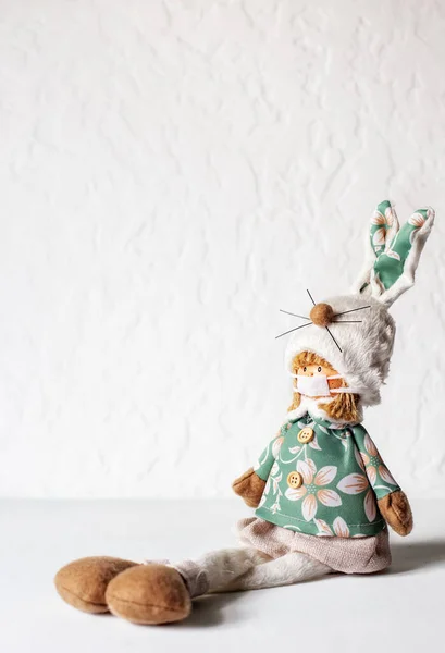 Tahta masa ve yeşil arka planda koruyucu tıbbi maskeli bebek. Dünya Coronavirüs Covid-19 salgını sırasında karantina. Salgın hastalık koruması. Hava kirliliği. Dikey, boşluğu kopyala