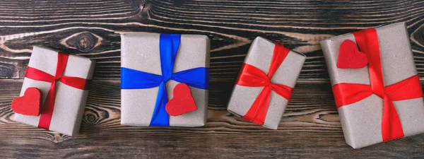 gift boxes with ribbons on wooden background