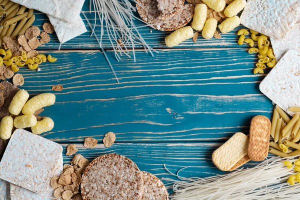 A variety of gluten-free foods on a blue wooden background. Top view. Gluten free food with copy space.
