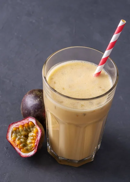 Fruit protein shake on a concrete background. Fresh milkshake with passion fruit. A glass of protein shake.