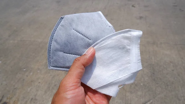 Hand holding the dust protection mask