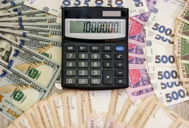 Ukrainian hryvnia, dollars, coins and calculator. Business concept.